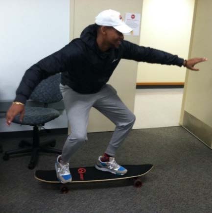 A student riding a longboard