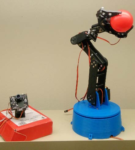 Photo of the robotic arm and a circuit