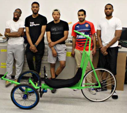Team members pose with the HPV