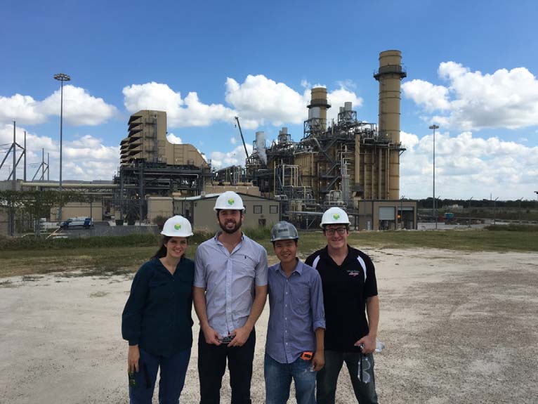 Team members pose in front of the Forney facility