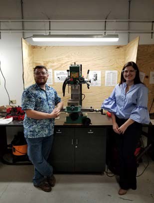 Team members pose by the testing bench