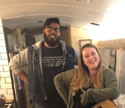 Team members pose inside the tiny home
