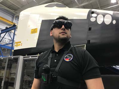 A student wearing AR goggles and chest band