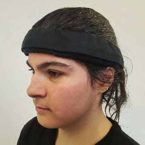 A girl wearing the device as a headband