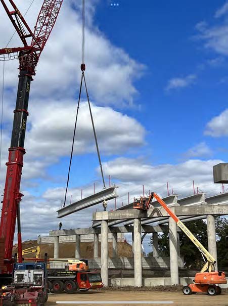 Photo of the construction site with a tall crane placing a bream