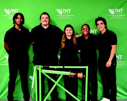 Team members pose with the crane