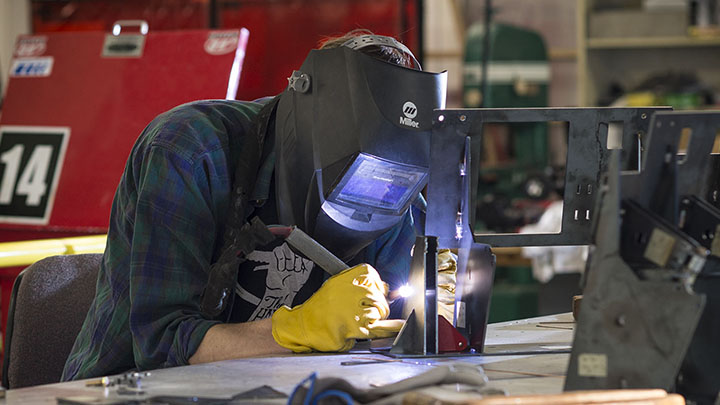 Worker welding mechanical frame