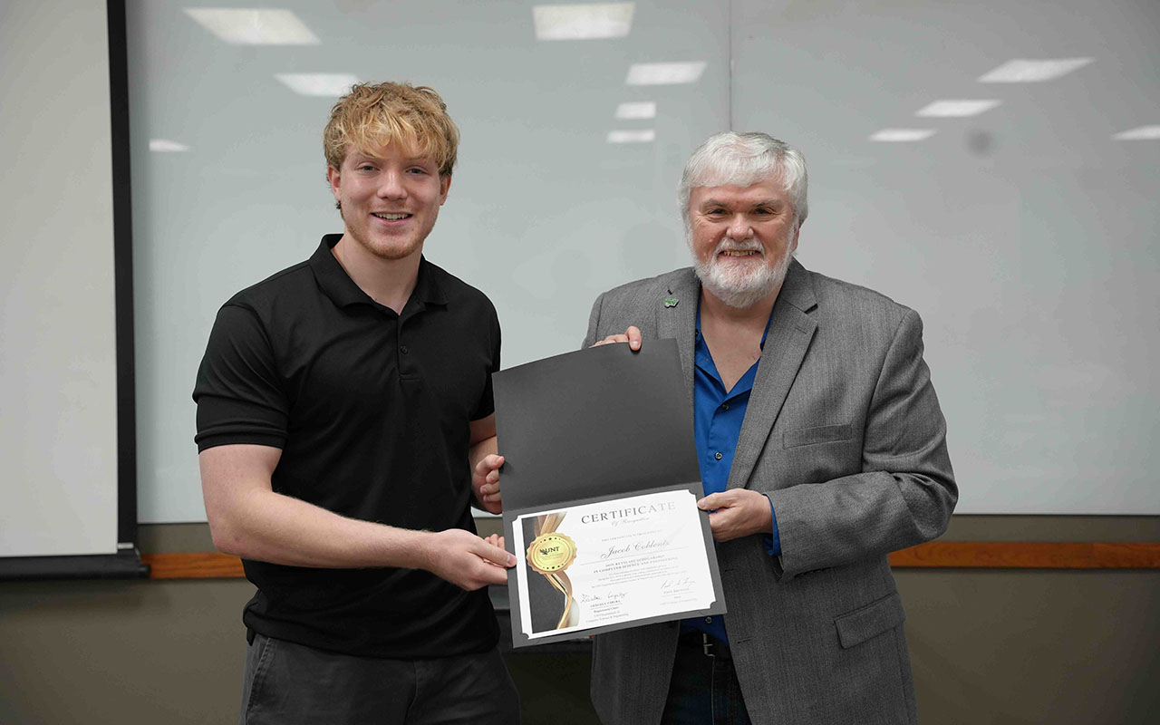 Student and professor posing with certificate