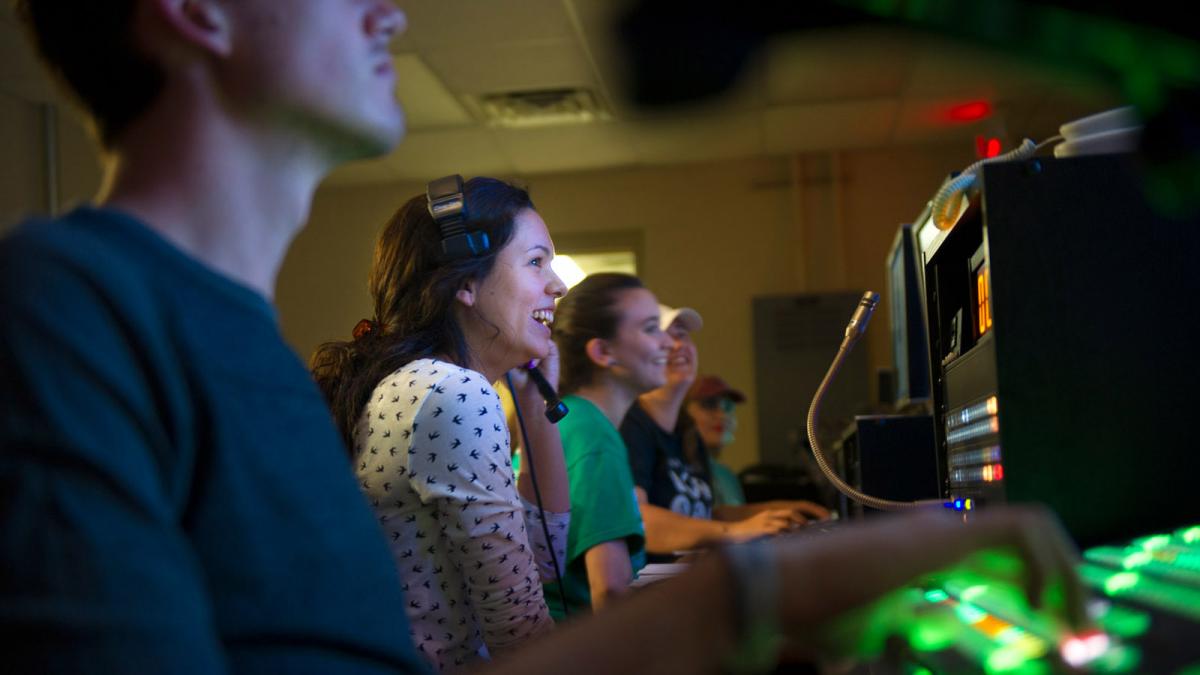 Students work in lab smiling