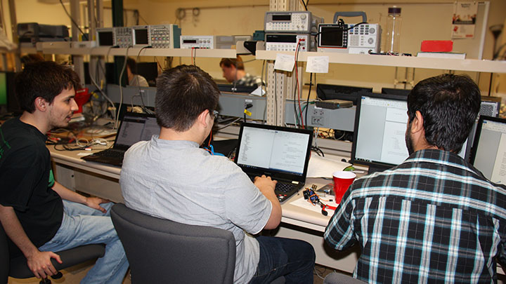 Undergraduate students working on senior design project in lab