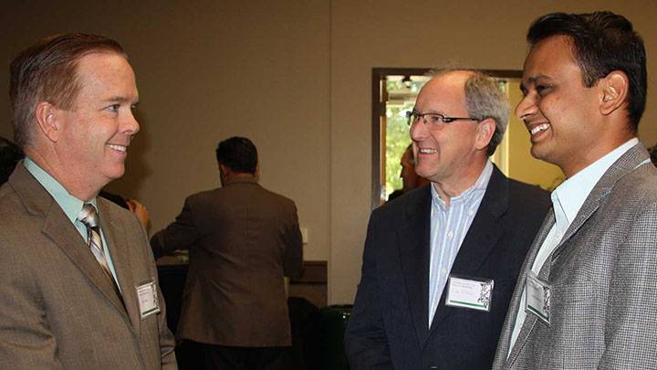 Three alumni talking to each other at EE 10 Year Anniversary.