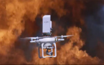 A white drone flying over flame and smoke