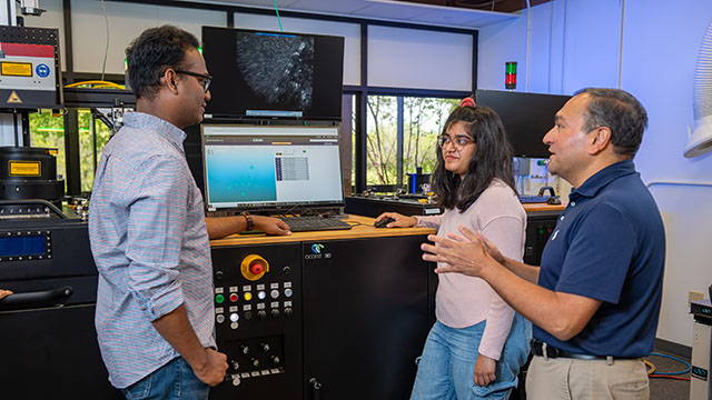 Faculty member advising two graduate students