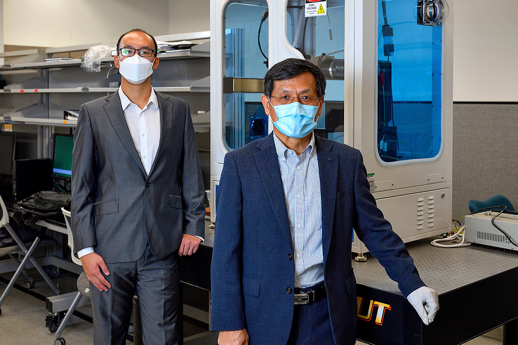 Choi and Jiang photographed in the lab wearing masks
