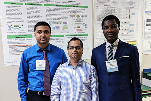 PhD students Sayeed and Olokodana pose with faculty Saraju Mohanty