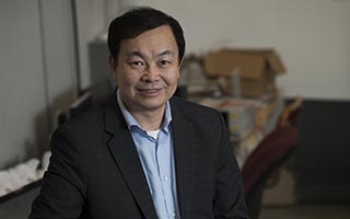 Haifeng Zhang stands in his lab