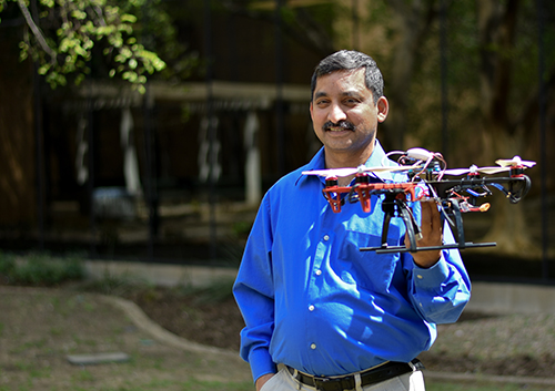 Dr. Kamesh Namuduri holding a drone