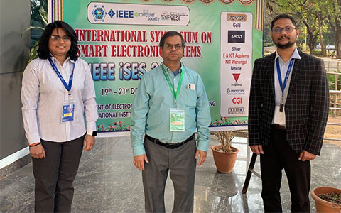 PhD Candidates Seema Aarella (on left) and Anand Bapatla (on right) with Professor Saraju Mohanty at IEEE-iSES 2022.