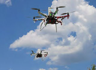 Drones flying in sky