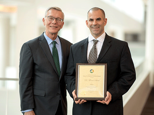 STLE President Michael Anderson presents award to Thomas Scharf.