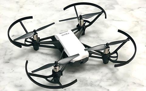 A black and white drone sits atop a marble counter.